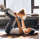 Mother and daughter yoga at home